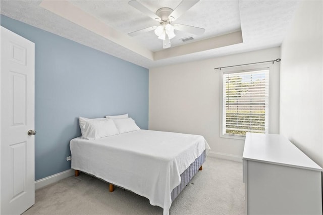 2260 Core Dr, Auburn, AL 36830 - bedroom featuring a raised ceiling, light colored carpet, and ceiling fan