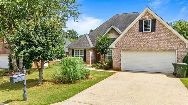 2260 Core Dr, Auburn, AL 36830 - traditional-style house with brick siding, driveway, a garage, a front lawn, and roof with shingles