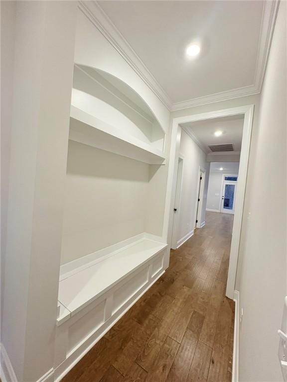 corridor with ornamental molding and dark hardwood / wood-style floors