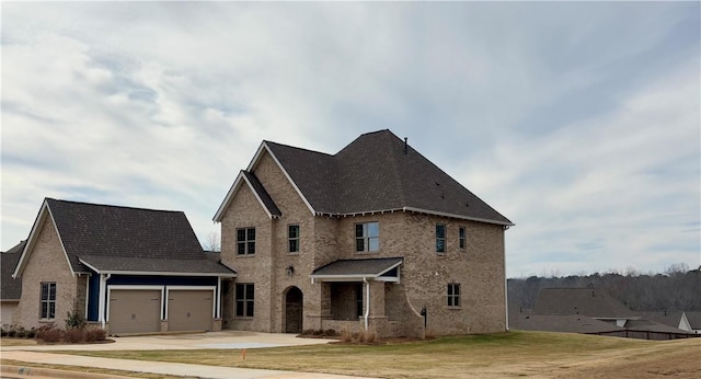 traditional home featuring a garage, brick siding, concrete driveway, and a front yard