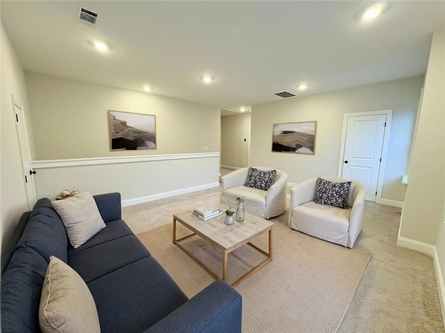 living room featuring recessed lighting, visible vents, and light carpet