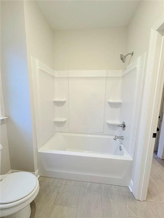 bathroom with toilet and tub / shower combination