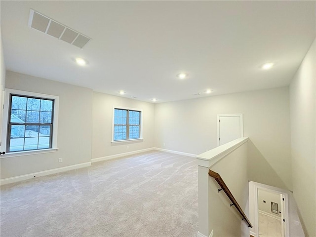 empty room featuring light colored carpet