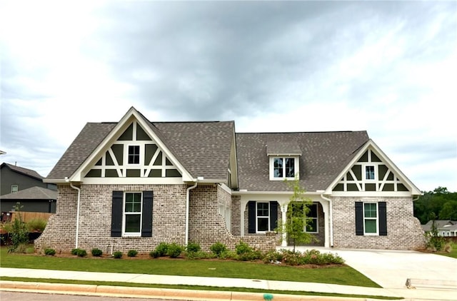 1649 James Burt Pkwy, Auburn, AL 36830 - tudor home featuring brick siding, a front lawn, and roof with shingles