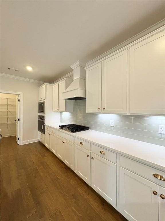 1649 James Burt Pkwy, Auburn, AL 36830 - kitchen with black oven, stainless steel microwave, premium range hood, ornamental molding, and white cabinetry