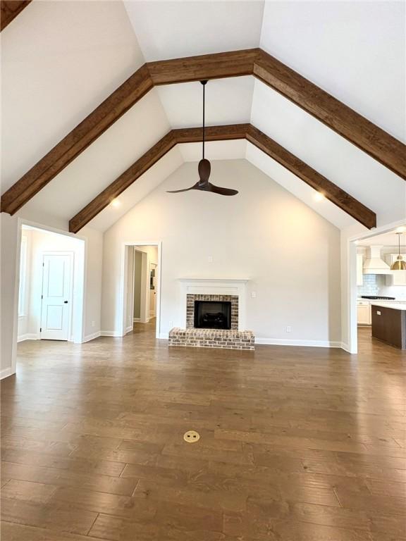 1649 James Burt Pkwy, Auburn, AL 36830 - unfurnished living room with ceiling fan, beamed ceiling, dark wood finished floors, a fireplace, and high vaulted ceiling