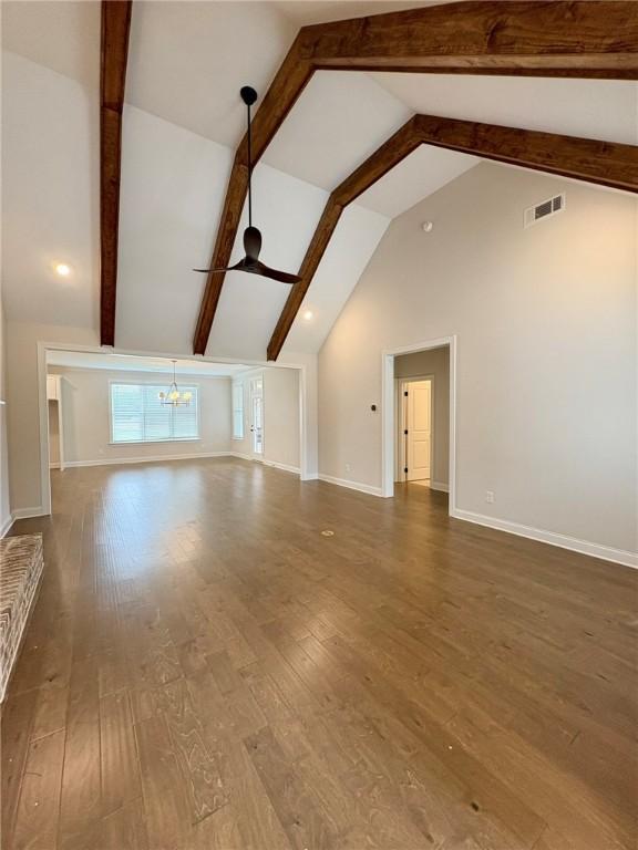 1649 James Burt Pkwy, Auburn, AL 36830 - unfurnished living room with a chandelier, wood-type flooring, beam ceiling, baseboards, and ceiling fan