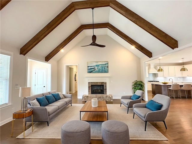 1649 James Burt Pkwy, Auburn, AL 36830 - living area featuring light wood finished floors, beam ceiling, ceiling fan, high vaulted ceiling, and a fireplace