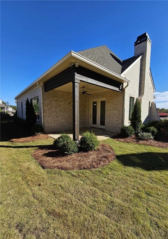 back of house with ceiling fan, a yard, a patio, and french doors