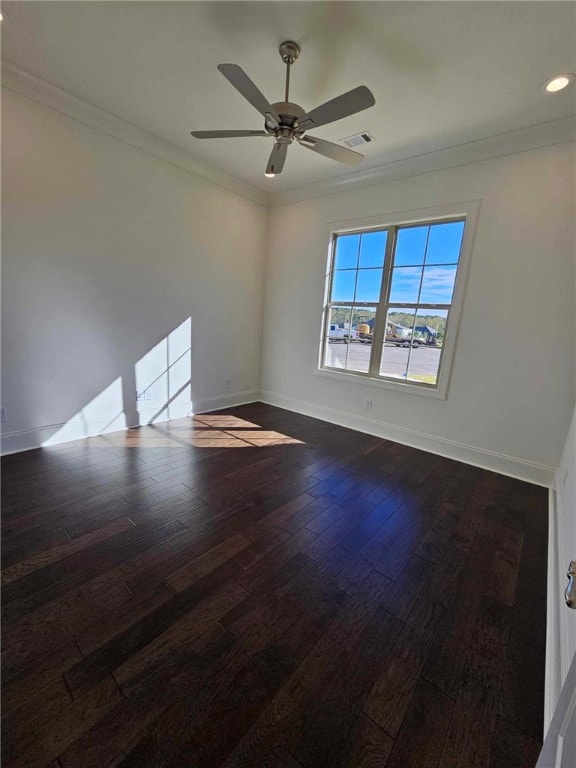 empty room with dark hardwood / wood-style floors, ceiling fan, and ornamental molding