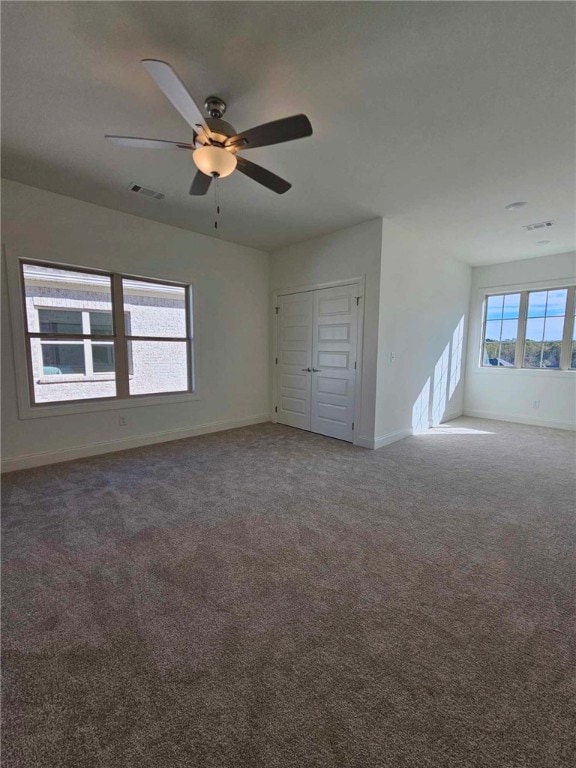 carpeted empty room with ceiling fan