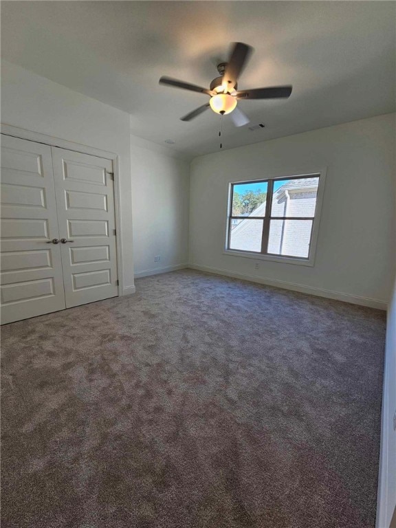 unfurnished bedroom with carpet floors, a closet, and ceiling fan