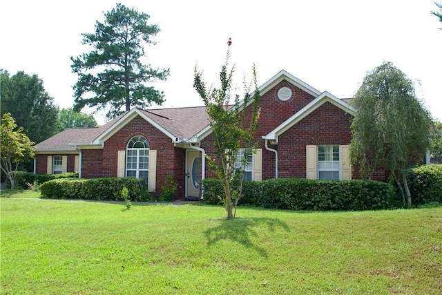 ranch-style house featuring brick siding and a front lawn