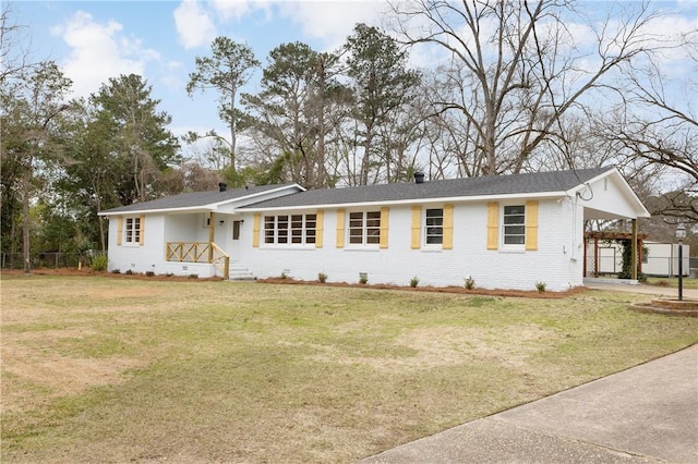 single story home featuring a front lawn and a carport