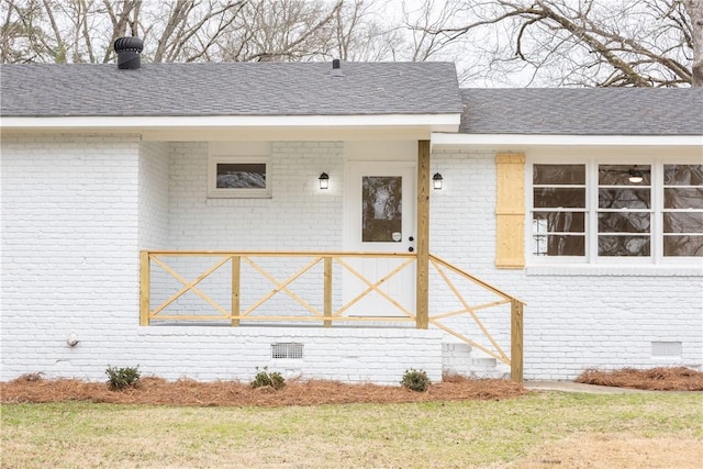 property entrance with a lawn