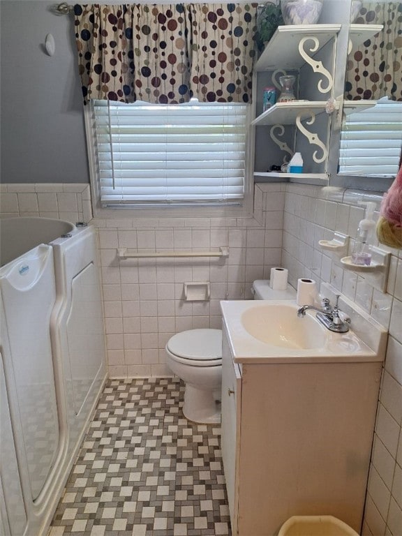 1701 53rd St, Valley, AL 36854 - bathroom with tile walls, vanity, a bath, plenty of natural light, and wainscoting