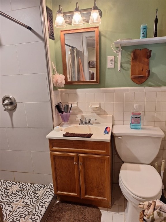 1701 53rd St, Valley, AL 36854 - bathroom featuring tiled shower, tile patterned floors, vanity, and tile walls