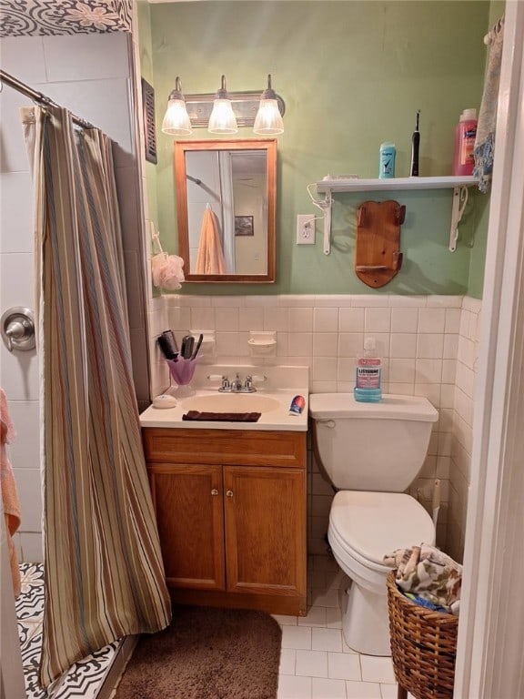 1701 53rd St, Valley, AL 36854 - bathroom with vanity, tile patterned floors, tile walls, a shower with curtain, and a wainscoted wall