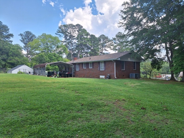 1701 53rd St, Valley, AL 36854 - rear view of house with a detached carport, brick siding, and a chimney