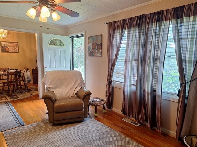 1701 53rd St, Valley, AL 36854 - living area with ornamental molding, wood finished floors, ceiling fan, and a chandelier
