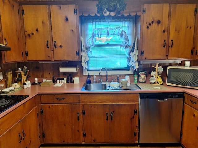 1701 53rd St, Valley, AL 36854 - kitchen with stainless steel dishwasher, light countertops, black electric cooktop, extractor fan, and brown cabinetry