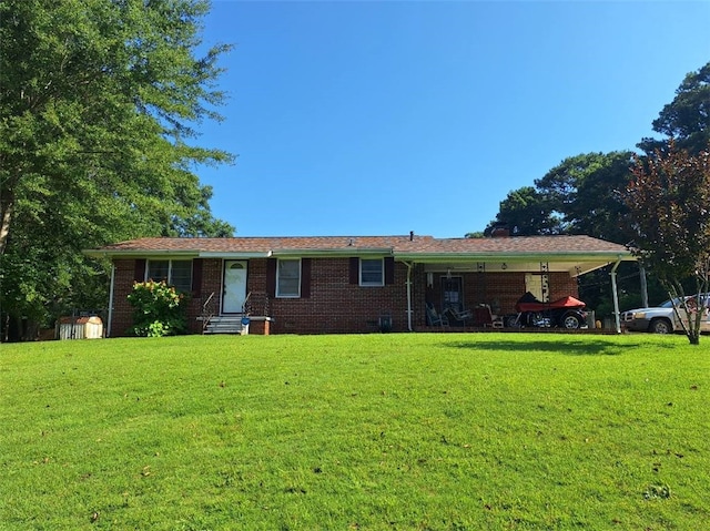 1701 53rd St, Valley, AL 36854 - rear view of house with a yard, a shed, brick siding, and entry steps