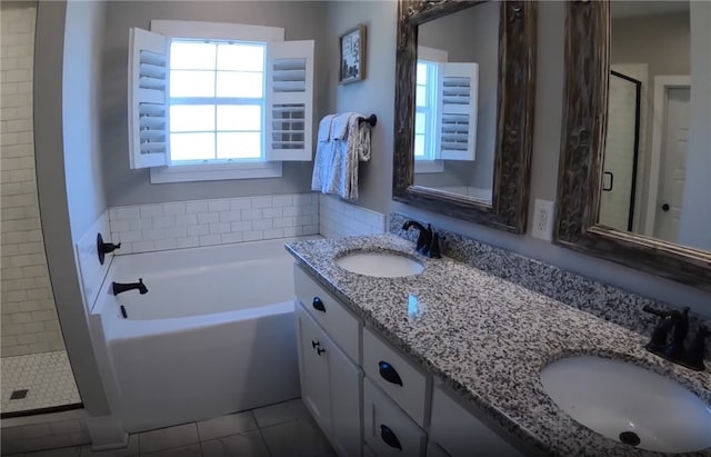 bathroom with vanity, tile patterned flooring, and plus walk in shower