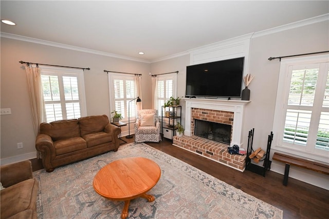 living room with hardwood / wood-style floors, ornamental molding, and a brick fireplace