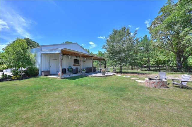 view of yard featuring an outdoor fire pit and a patio area