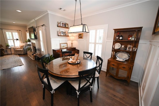 dining room featuring ornamental molding and dark hardwood / wood-style floors