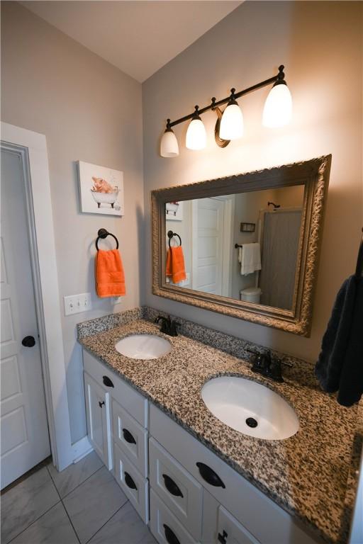 bathroom featuring vanity and toilet