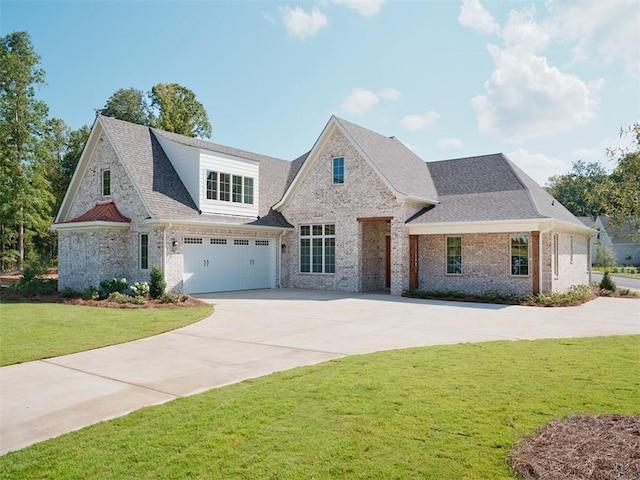 view of front of property with a garage and a front lawn