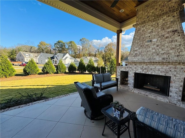 view of patio featuring an outdoor living space with a fireplace