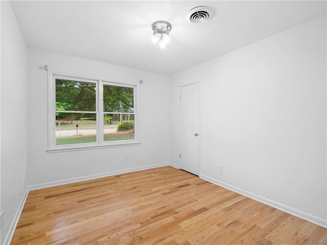 spare room with light hardwood / wood-style flooring