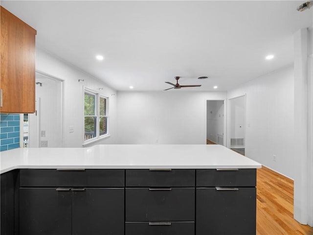 kitchen with ceiling fan and light wood-type flooring