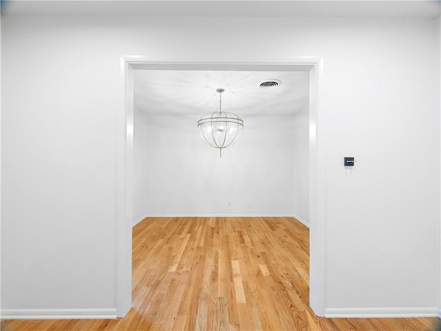 interior space with a chandelier and wood-type flooring