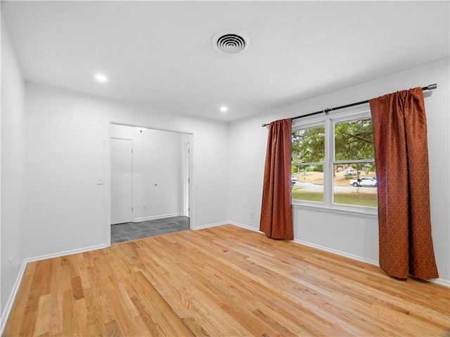 spare room with light hardwood / wood-style floors