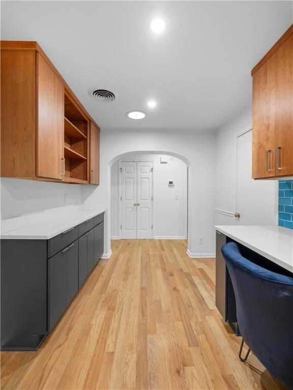 kitchen with decorative backsplash and light wood-type flooring