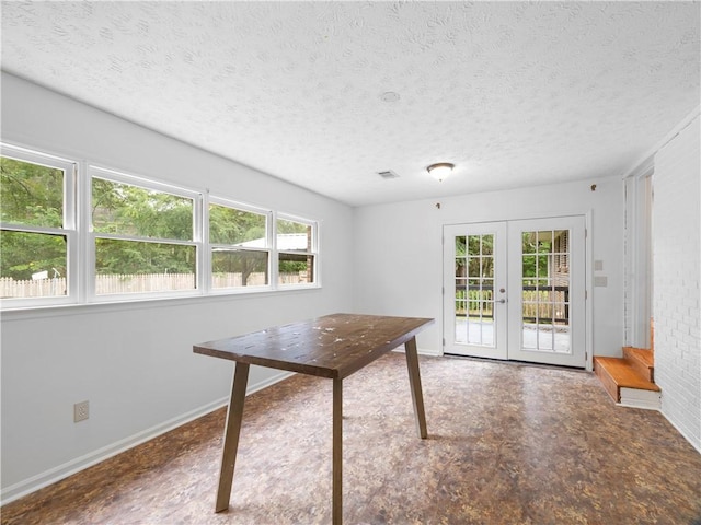 interior space featuring a textured ceiling and french doors