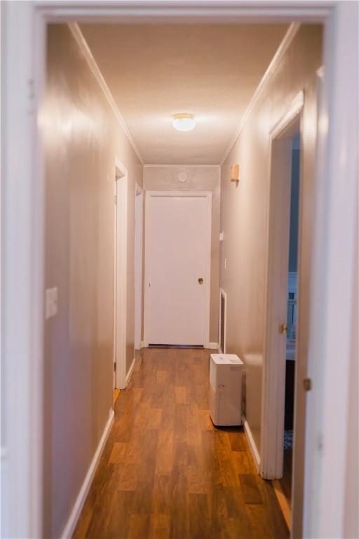 2401 11th Ave, Valley, AL 36854 - corridor with ornamental molding, wood finished floors, and baseboards