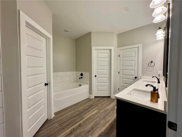 bathroom featuring a bathtub, vanity, and hardwood / wood-style floors