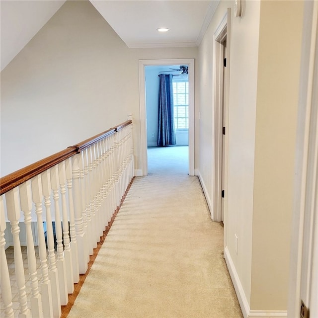 hall with light colored carpet and ornamental molding