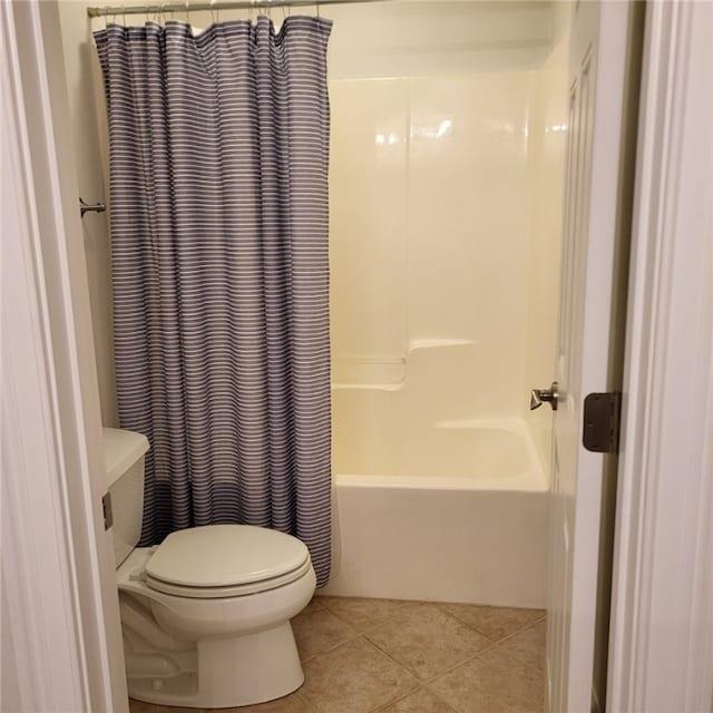 bathroom featuring tile patterned floors, toilet, and shower / bathtub combination with curtain