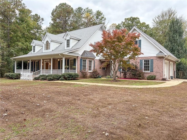 cape cod-style house with a porch, a garage, and a front yard