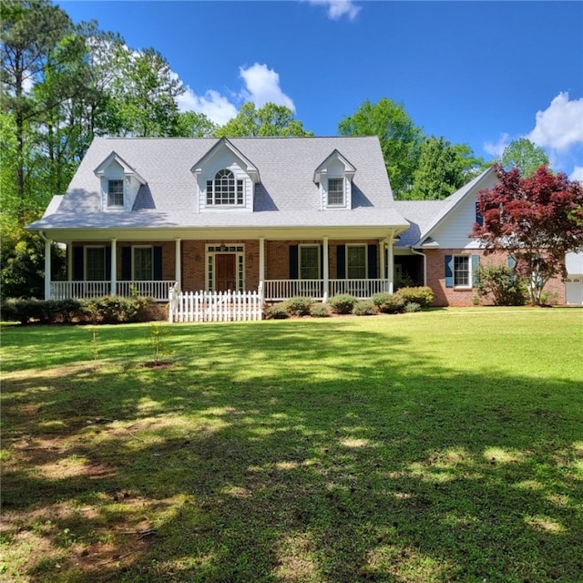 1155 County Road 517, Lanett, AL 36863 - cape cod home with covered porch, brick siding, and a front lawn