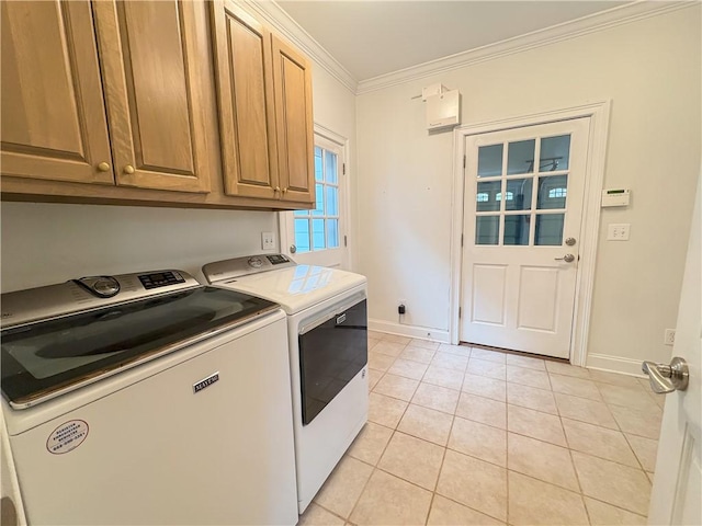 laundry area featuring cabinets, washing machine and dryer, crown molding, and light tile patterned flooring