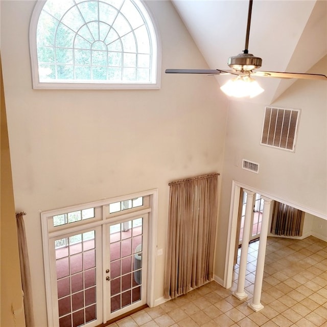 tiled entryway featuring french doors, high vaulted ceiling, and ceiling fan