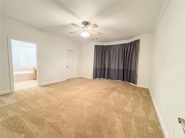 carpeted empty room with ceiling fan and ornamental molding