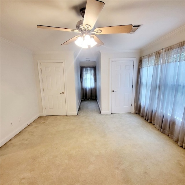 unfurnished bedroom with light carpet, ceiling fan, and ornamental molding