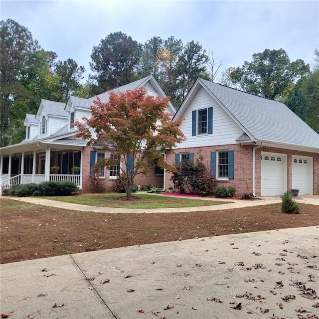 view of front of home with a porch, a garage, and a front yard